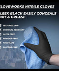 Close-up: GloveWorks black nitrile glove on hand gripping a blue textured microfiber cleaning cloth for cleaning tasks