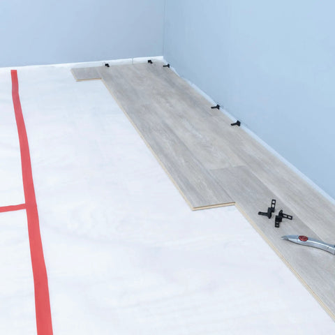 No Nonsense Foam Underlayment Roll Quiet Room Padding For Laminate And Engineered Wood Flooring Radiant Heat Ready laying over white subfloor.
