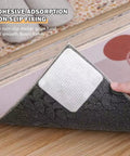 Hand applying non slip rug pad grippers to rug corner on hardwood floor, demonstrating adhesive grip, 3.9 inch size, square