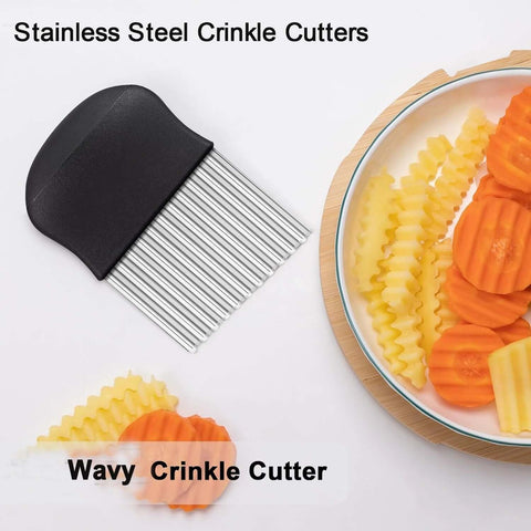 Stainless steel crinkle cutter with black non-slip handle; side view beside sliced vegetables