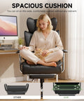 Woman sitting cross-legged on Big And Tall Leather Office Chair With Footrest High Back Ergonomic Gaming Chair Pocket Spring Lumbar Support And Outward Fixed Soft Armrests For Executive Comfort And All Day Back Support, with a cat in her lap