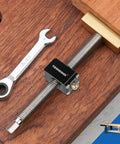 All Metal Bench Dog Clamp With Three Quarter Inch Quick Release Mechanism For Woodworking Mft Table And Workshops Heavy Duty Ratcheting Design. Close-up of clamp with wrench on wooden surface.