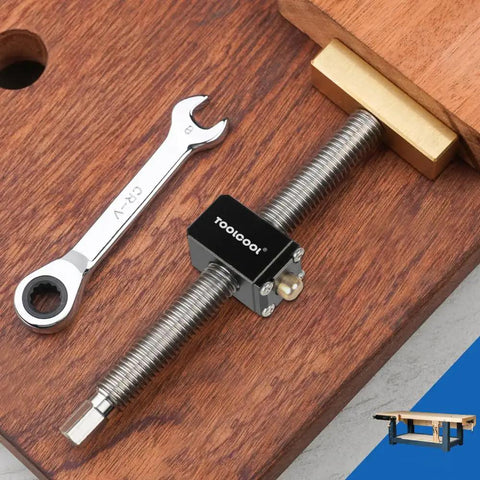 All Metal Bench Dog Clamp With Three Quarter Inch Quick Release Mechanism For Woodworking Mft Table And Workshops Heavy Duty Ratcheting Design. Close-up of clamp with wrench on wooden surface.