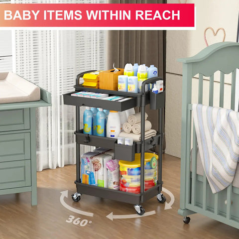 Three Tier Rolling Utility Cart With Removable Drawer Sturdy Black Mobile Storage Cart On Two Lockable Wheels For Kitchen, Bathroom, Craft Room, Makeup Station, Snack Bar And Baby Essentials filled with baby supplies next to nursery furniture