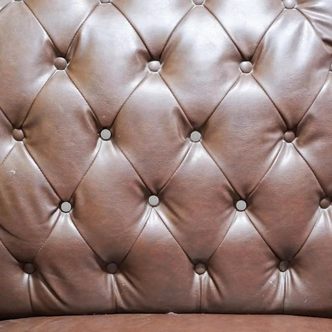 Kick Up Your DIY Game With Sleek Stainless Steel Upholstery Tacks Delivered Straight To Your Door With Top Shelf Decorative Furniture Nails Designed For Easy Sofa And Headboard Projects on a tufted leather headboard.