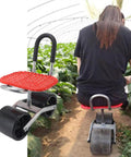 Wheeled garden stool with adjustable height iron construction used for labor-saving outdoor planting in a greenhouse.