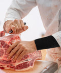 High Density Cut Resistant Arm Sleeves Two Pack Legit Tough As Nails Forearm Guards used while cutting meat for safety.