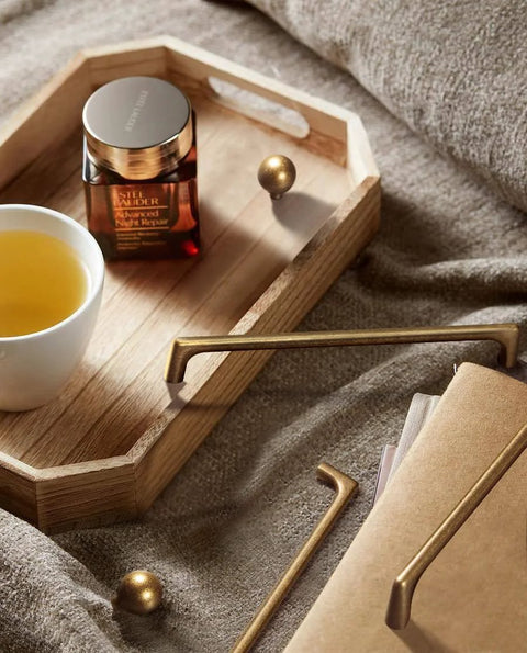 Antique Brass Cabinet Pulls 5 Inch Hole Centers 128mm Zinc Alloy Handles displayed with a wooden tray and a cup of tea