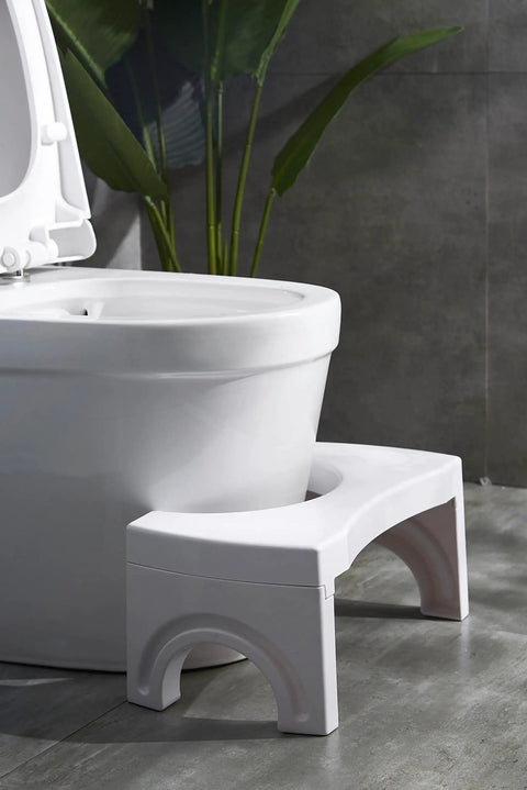 Foldable Toilet Stool Foot Rest Made For Real Squat Posture 7.5 Inch White Bathroom Hack To Ease Straining And Beat Constipation Sturdy ABS Build Portable Squatting Potty For Home next to toilet