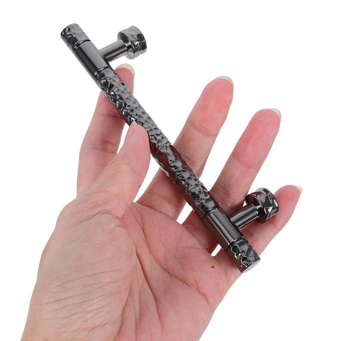 Hand holding zinc alloy cabinet pull handles for kitchen and bath, knurled retro wardrobe drawer hardware