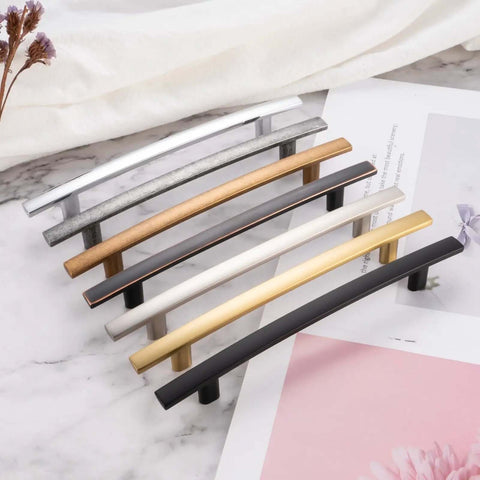 Snag These Tough Matte Black Cabinet Pulls Curved Look 3 Inch Hole Centers 10 Pack Solid Metal Drawer Handles Rust Free Kitchen Furniture Grips With Screws displayed in various finishes on a marble surface.
