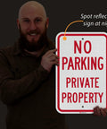 Tough As Nails No Parking Private Property Sign 12 X 18 Inch Heavy Duty Aluminum Sheet shown held by a man.