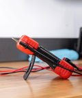 Red and black Auto-Ranging Digital Multimeter For Automotive And Home Electrical Troubleshooting UL Certified Handy Tool on table