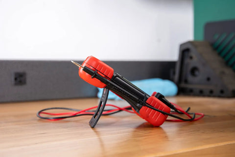 Red and black Auto-Ranging Digital Multimeter For Automotive And Home Electrical Troubleshooting UL Certified Handy Tool on table