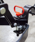 Extra Strong Quick Connect Magnetic Hitch Pin attached to sleeve hitch on tractor, red handle visible, heavy duty steel pin.