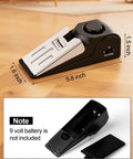 Door Stop Alarm 2 Pack With 120dB Siren Floor Wedge Door Stopper And Security Alarm Travel Friendly For Hotels Apartments And Home Use Anti Slip Mesh Bottom Inner Door Fit 0.6 To 1.2 Inch Black shown on wooden floor with size dimensions and battery compartment