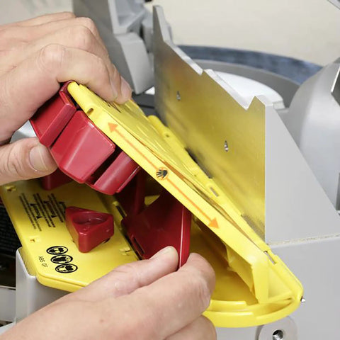 Crown Molding Cuts Made Super Easy With This Solid Miter Saw Jig adjusting yellow jig for precise 38 45 and 52 degree crown molding cuts.