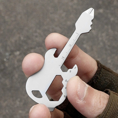 Person holding Stainless Steel Multitool Keychain With Bottle Opener Screwdriver Imperial And Metric Ruler And Bike Spoke Key