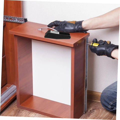 Person installing Two Pack Rubber Toggle Latch Clamps For Secure Storage And Quiet Draw Latches on wooden cabinet door.