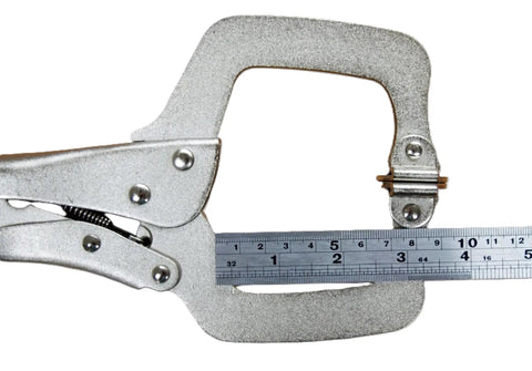 Close-up of a No Sweat Grip Locking C Clamp Pliers Set Of Four 11 Inch Swivel Jaw Welding Clamp with measuring ruler.