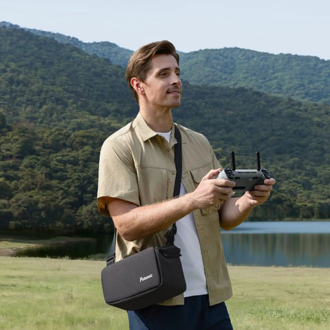 Man operating Atom 2 Fly More Drone Combo With RC PTD 1 For Adults 4K Video 8K Photo in outdoor landscape