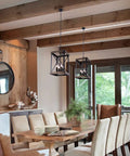 Dining room with Four Light Wood Grain Black Cage Pendant Lamp For Kitchen Island And Dining Room hanging over wooden table