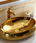 Heavy Duty Ceramic Vessel Sink For Modern Bathrooms With Included Faucet Dope Gold Oval Basin on countertop with sleek design.