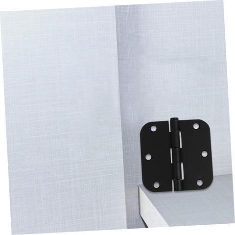 Black iron rounded-corner door hinge mounted on a light gray cabinet door