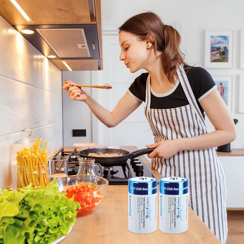 Eight Pack Rechargeable D Batteries With USB Charging Cable in kitchen with woman cooking, showcasing long lasting power for devices