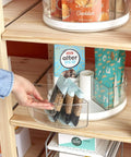 Hand removing clear bin from 360 Degree Rotating Lazy Susan Organizer With 3 BPA Free Removable Clear Bins With Handles Shelf
