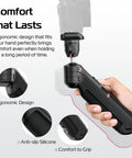 Hand holding One-Click Opening Vlogging Tripod With Quick-Release System, close-up of ergonomic grip and anti-slip silicone details.