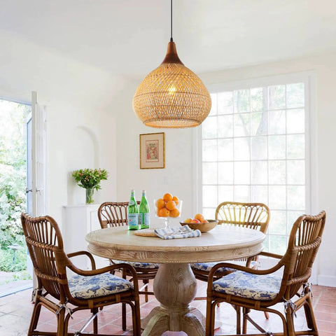 Hand Woven Rattan Pendant Light With Sturdy Wood Frame, 15 Inch Boho Ceiling Fixture For Kitchen Island And Dining Room hanging over a wooden dining table.