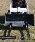 Front view of Beefy 60 Inch Clamp On Pallet Forks for Loaders and Skid Steers attached to loader bucket, 47 inch long forks.