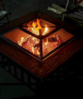 32 Inch Square Fire Pit Table With Spark Screen, Fire Poker, And Ice Bucket Cooler, 3 In 1 Outdoor Fire Pit in use at night