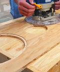 User operating a router with No Fuss Setup Circle Guide Kit And Drill Block Bundle For Exact Router Cutouts and Bullseye Handheld Drilling.