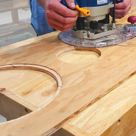 User operating a router with No Fuss Setup Circle Guide Kit And Drill Block Bundle For Exact Router Cutouts and Bullseye Handheld Drilling.