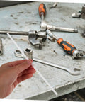 Hand holding a white rod with tools around, showcasing the 10 Pcs Car Bumper Welding Rods for Quick Bumper Repairs, DIY friendly.