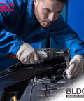 Mechanic using 12V Beefy Cordless Brushless Ratchet Wrench, One Quarter Inch Drive, 45 Foot-Pounds in automotive engine bay.