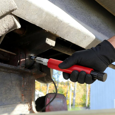 Person using a red Grease Fitting Cleaner Tool Kit Hydraulic Powered Zerk Buster And Rejuvenator for clearing clogged bearings.