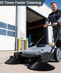 42 Inch Walk Behind Floor Sweeper With Dual Side Brushes And Fifteen Gallon Dustbin For Warehouses Driveways And Garages Crushes Dirt For Real Straight Up Smooth Operator That Handles Tough Jobs Daily being used outdoors on a concrete surface.