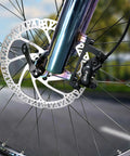 Z00M hydraulic brake caliper and disc rotor installed on front e-bike wheel; black caliper, silver rotor