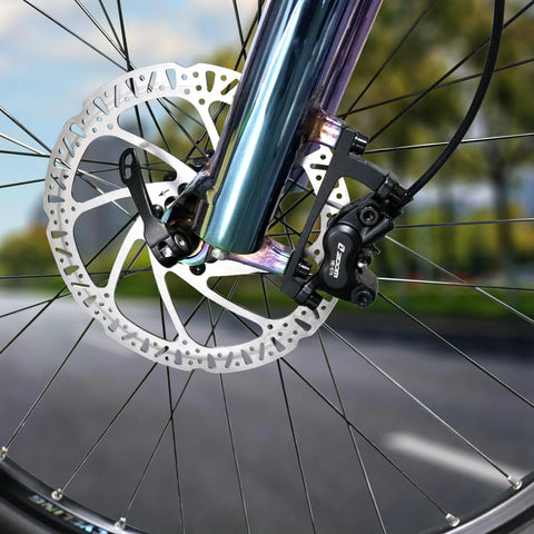 Z00M hydraulic brake caliper and disc rotor installed on front e-bike wheel; black caliper, silver rotor