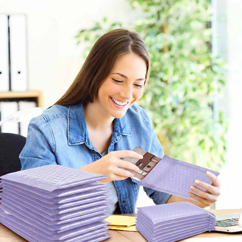 Woman using 100 Count Bubble Mailer Set Four Sizes Self Adhesive Waterproof Padded Envelopes For Shipping And Mailing Cushioning Seal