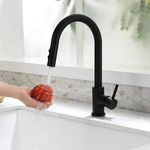 Black Kitchen Faucet With Pull Down Sprayer And Single Handle Pullout Design in use, washing a tomato in farmhouse RV bar sink
