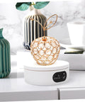Rotatable Jewelry Display Stand With Electric Motorized Turntable Skid Base showcasing a crystal apple design on a white base.
