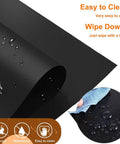 Close-up of Upgraded Cuttable Gas Burner Covers For Stovetop Easy Clean Reusable Nonstick Liners, water droplets on black surface.