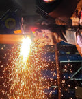 Pro Grade P80 Plasma Cutter Consumables Kit 45 pieces in action cutting steel with sparks flying, 80A system use