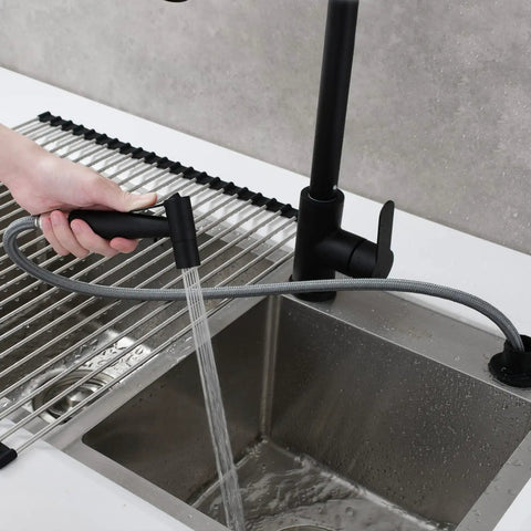 Person using Stainless Steel Kitchen Sink Side Sprayer Set With Pull Out Hose And Holder, Black Finish