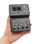 Hand holding Two Channel DJ Mixer For Laptop Tablet And Phone With 16Bit 48KHz Audio Resolution Portable Pro Mixing Console