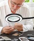 Man using LED Magnifying Lamp With Flexible Gooseneck 5X And 10X Lenses 3 Color Modes Soldering Helping Hands Base Station for repair work